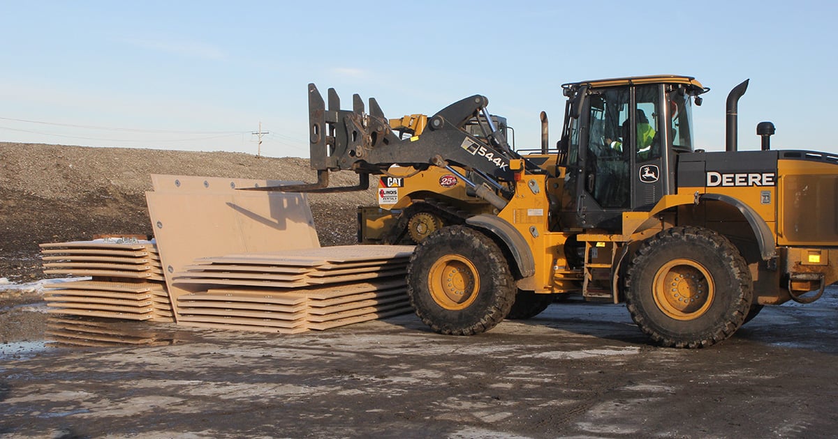Composite construction mats used with heavy equipment