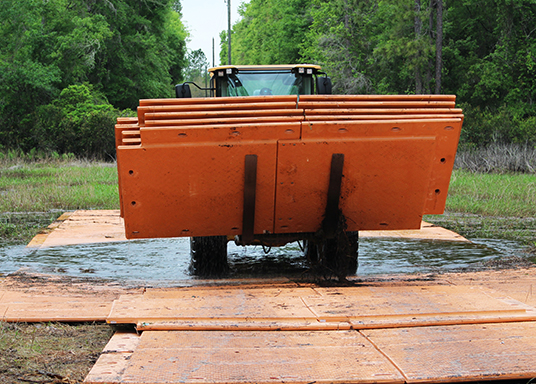 Logging mats supporting heavy equipment